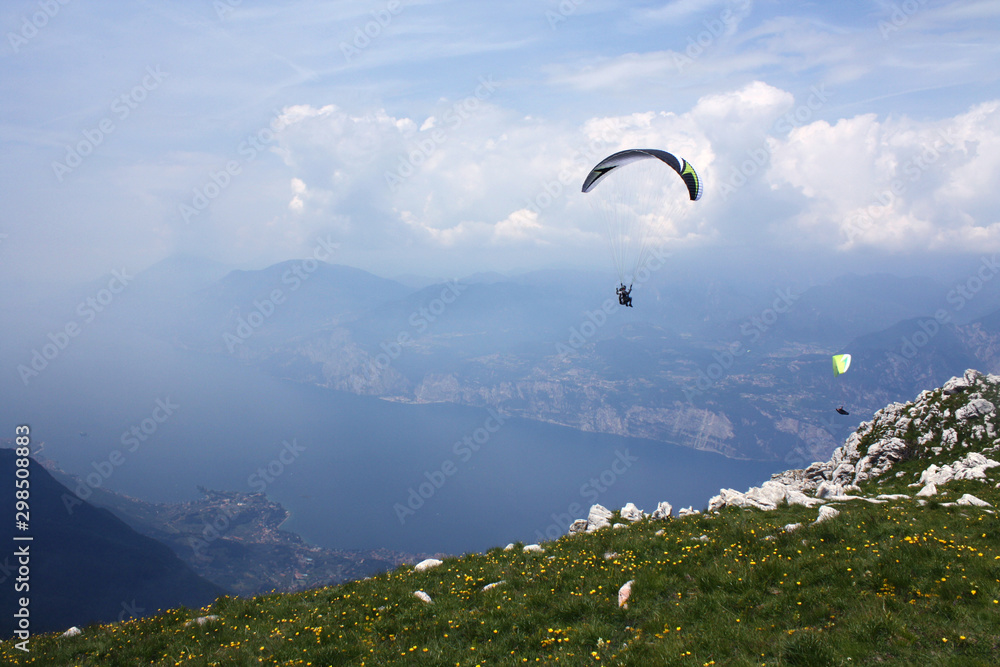 Paraglider over Lake Garda, Italy, on a summer day Paraglider over Lake Garda, Italy, on a summer day