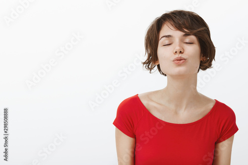 Wanna feel your love. Lovely romantic cute woman lean foward give kiss fold lips close eyes happily awaiting muah express sympathy standing beautiful park passionate date white background