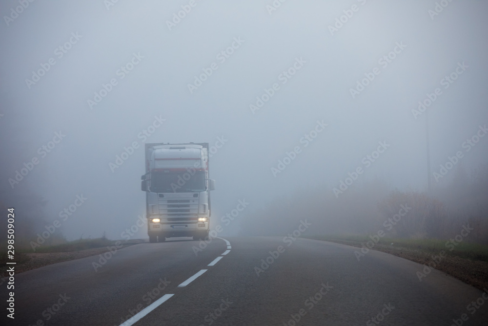 Truck on the road in the fog