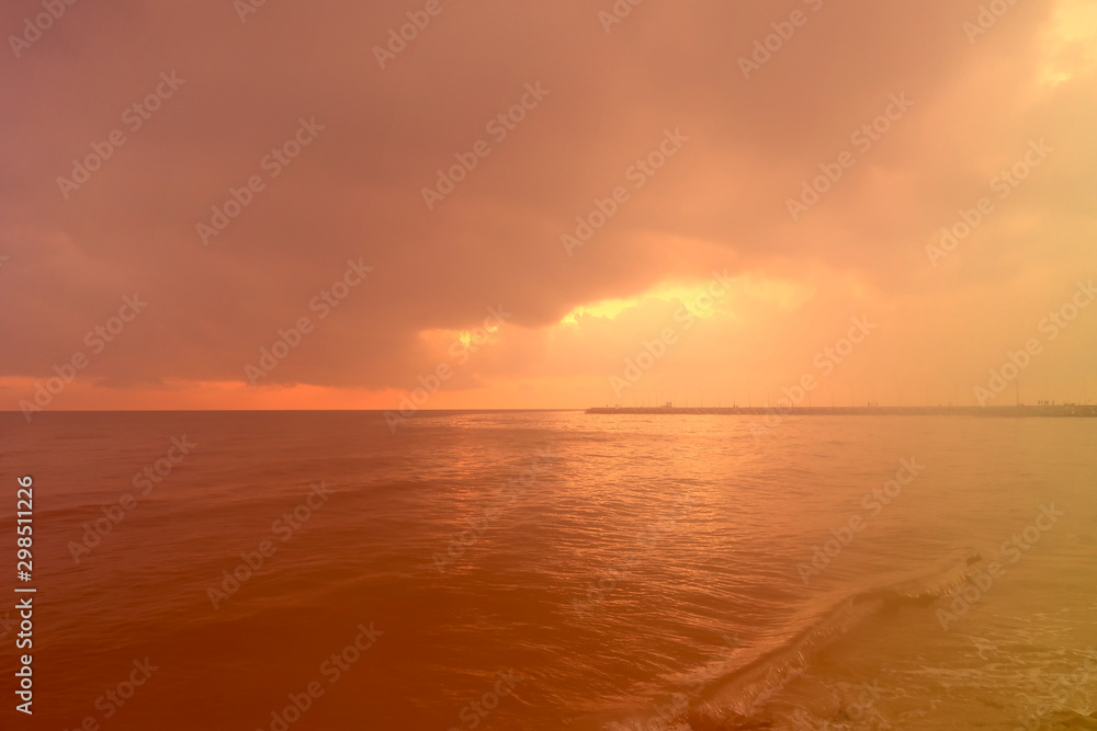 sunrise through the cloud over the sea and fantastic color of light