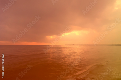 sunrise through the cloud over the sea and fantastic color of light