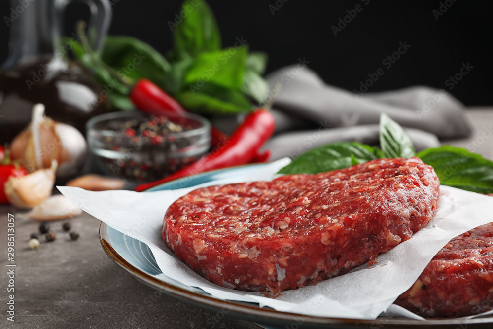Raw meat cutlets for burger on table, closeup Raw meat cutlets for burger on table, closeup