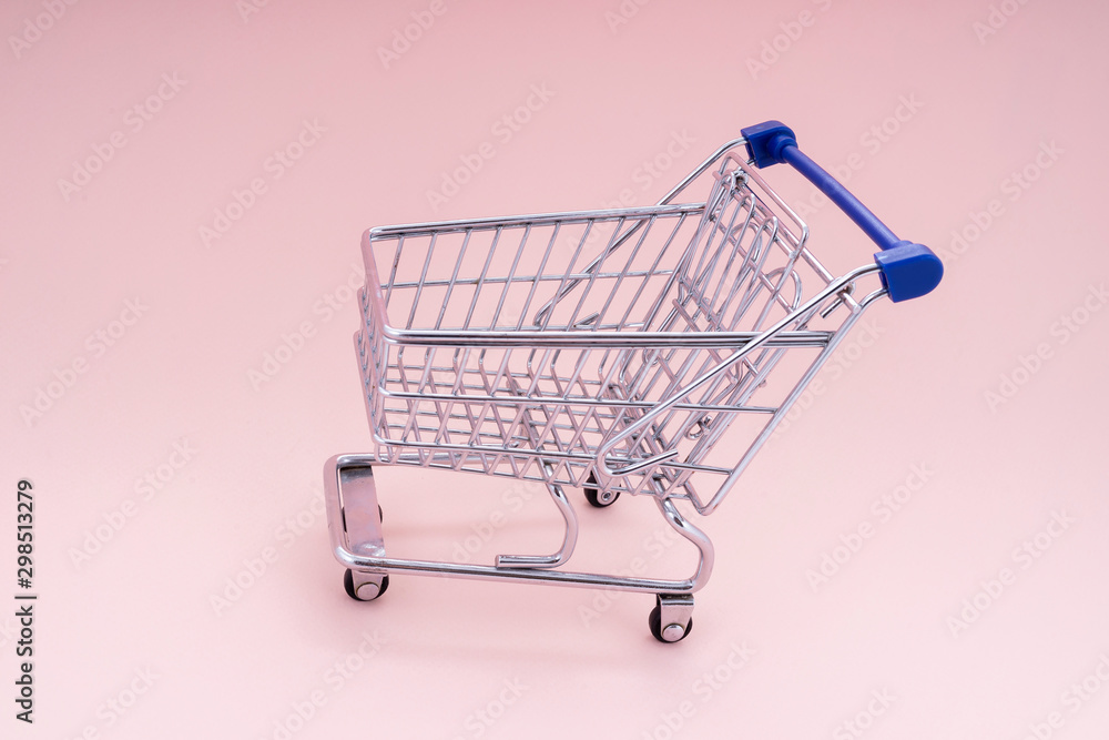 empty shopping cart over pink background empty shopping cart over pink background