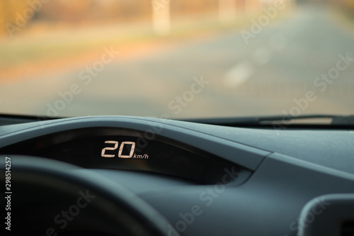 Speed 20 kilometrs per hout on a dashboard of a car; speed limit concept; safety driving
