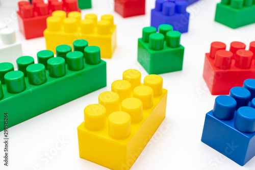 Many colorful toy plastic bricks, kit of blocks for building and constructing on white background, Children's game and playing concept