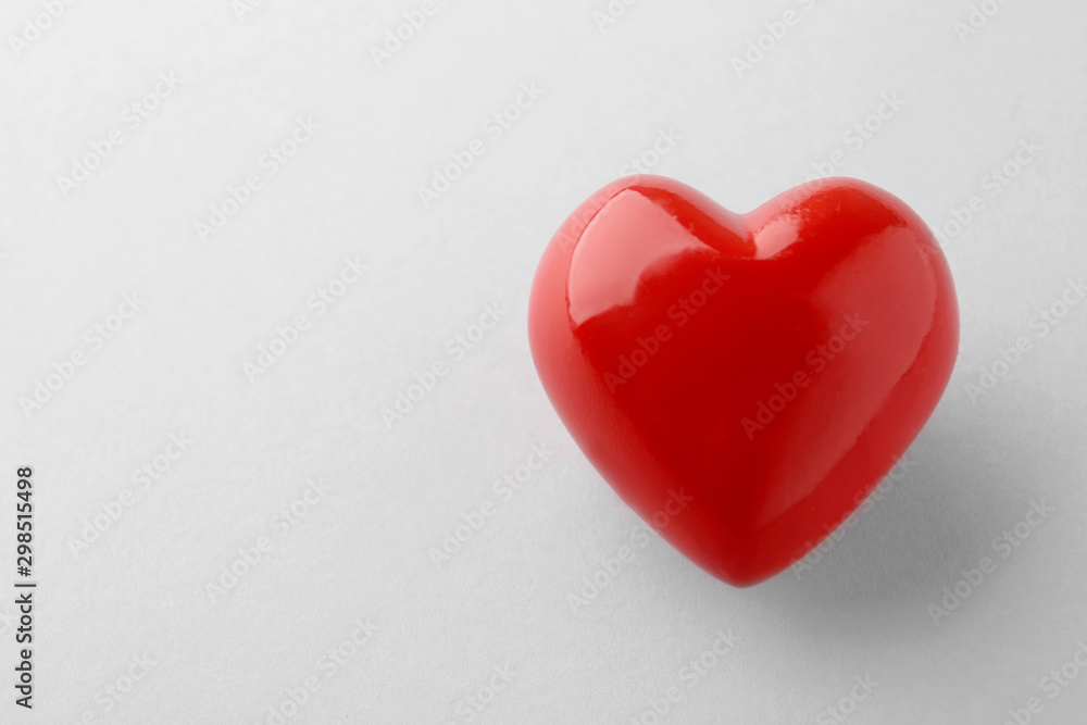 Shiny red heart on white background, top view Shiny red heart on white background, top view
