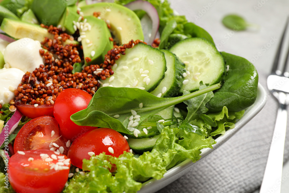 Delicious avocado salad with quinoa on light grey table, closeup Delicious avocado salad with quinoa on light grey table, closeup