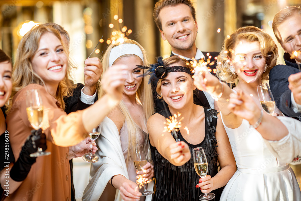 Well-dressed people celebrating New Year indoors