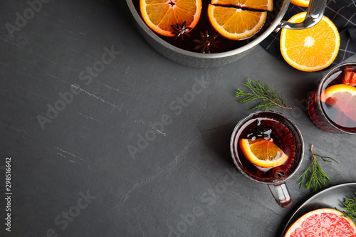 Flat lay composition with tasty mulled wine on black table. Space for text