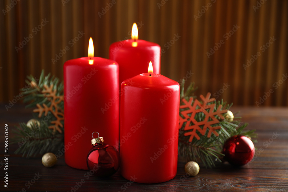 Beautiful composition with candles and Christmas decor on wooden table Beautiful composition with candles and Christmas decor on wooden table