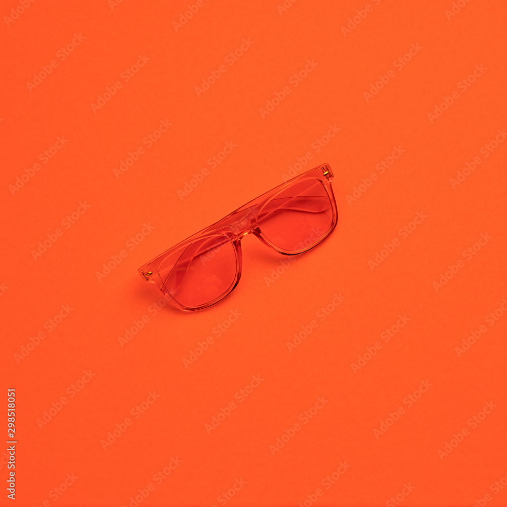 Minimal fashion, Trendy sunglasses. Party vibration on orange geometry background. Hipster accessory Flat lay. Art creative summer vibes fashionable pop art style. Design vibrant color, gel filter Minimal fashion, Trendy sunglasses. Party vibration on orange geometry background. Hipster accessory Flat lay. Art creative summer vibes fashionable pop art style. Design vibrant color, gel filter