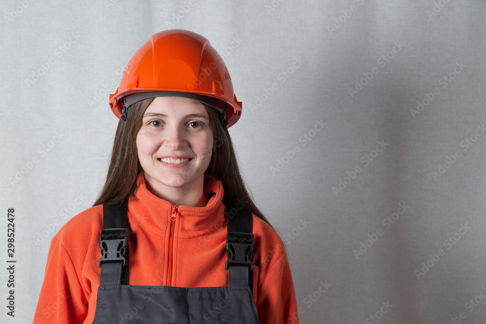 Portrait of a beautiful girl in a construction helmet. Portrait of a beautiful girl in a construction helmet.