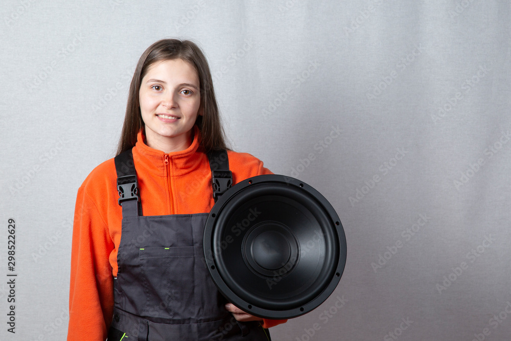 Portrait of a beautiful girl with a subwoofer. Car audio system. Stock  Photo | Adobe Stock