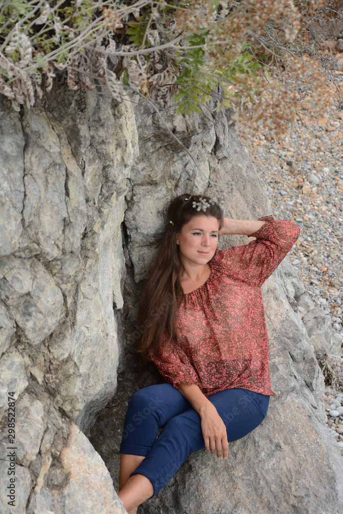 Happy woman relaxing and enjoying at the beach during travel holidays vacation outdoors at ocean or nature sea Happy woman relaxing and enjoying at the beach during travel holidays vacation outdoors at ocean or nature sea