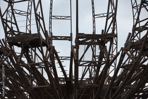 Metallic iron sphere structure. Rusty beams. Abstract shape symbol. Close-up detail shot.