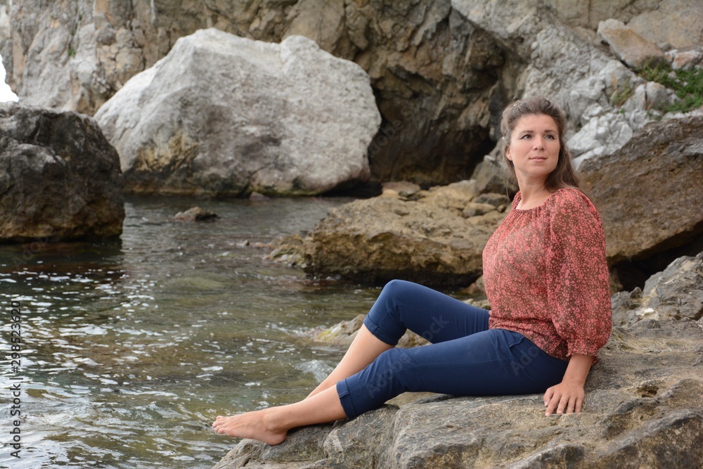 Happy woman relaxing and enjoying at the beach during travel holidays vacation outdoors at ocean or nature sea Happy woman relaxing and enjoying at the beach during travel holidays vacation outdoors at ocean or nature sea