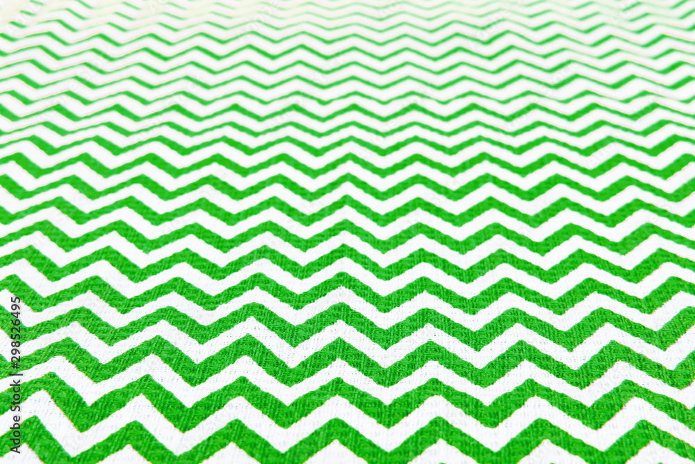 Fototapeta Green and white fabric tablecloth zigzag pattern receding into the distance, Christmas and New Year background, copy space