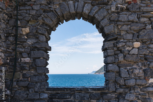 Panoramic view of the Mediterrean Sea through an antique arc in Portovenere Cinque Terre