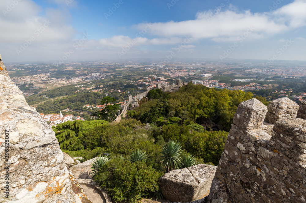 Scenic view of medieval hilltop castle Castelo dos Mouros (The Castle of the Moors) and Sintra municipality and beyond from above in Portugal.
