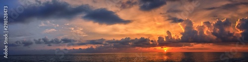 Phuket beach sunset, colorful cloudy twilight sky reflecting on the sand gazi...