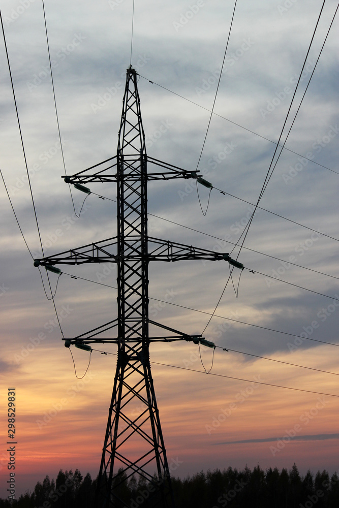 Electricity pylon with beauty sunset in the field