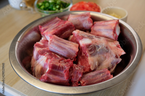Cutted oxtail in a bowl. Raw meat