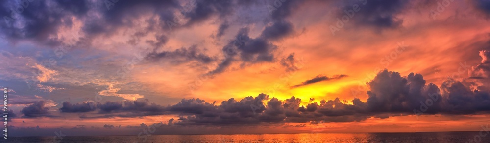 Phuket beach sunset, colorful cloudy twilight sky reflecting on the sand gazing at the Indian Ocean, Thailand, Asia. Phuket beach sunset, colorful cloudy twilight sky reflecting on the sand gazing at the Indian Ocean, Thailand, Asia.