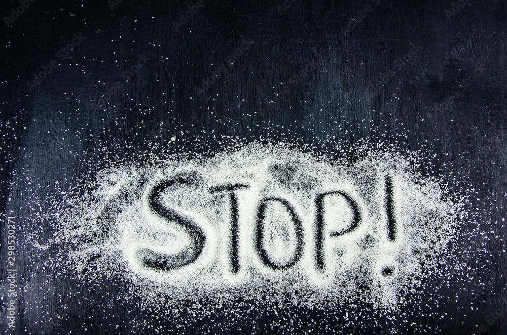 top view of the word stop on the sugar sand - obrazy, fototapety, plakaty 