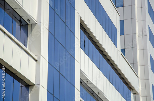 Modern architectural background of metal panels and blue glazing
