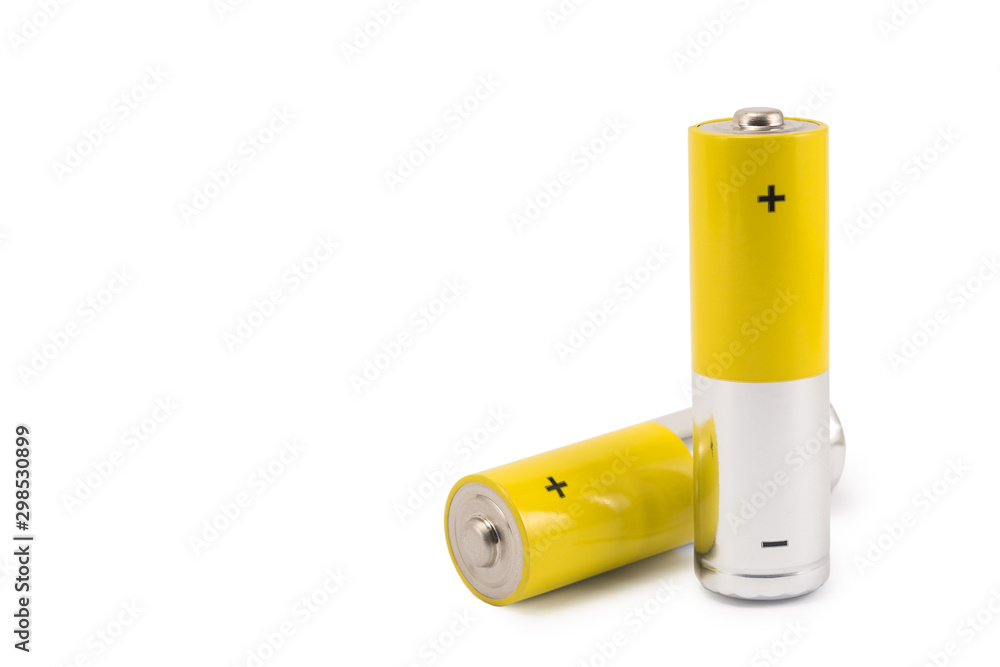 alkaline batteries and a yellow metal AA-size batteries isolated on white background closeup, carbon zinc batteries, rechargeable batteries, mockup alkaline batteries and a yellow metal AA-size batteries isolated on white background closeup, carbon zinc batteries, rechargeable batteries, mockup