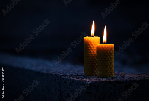 Two candles with beeswax on the monument photo