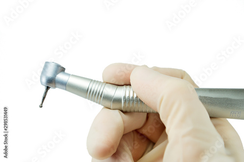 Fotografie dental handpiece in the hands of the dentist isolated on white background close-