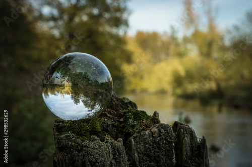 Glass spere on a silent river. photo