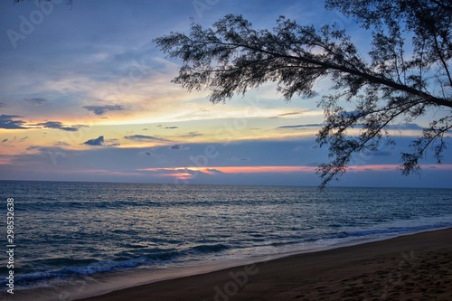 Phuket beach sunset  colorful cloudy twilight sky reflecting on the sand gazing at the Indian Ocean  Thailand  Asia.