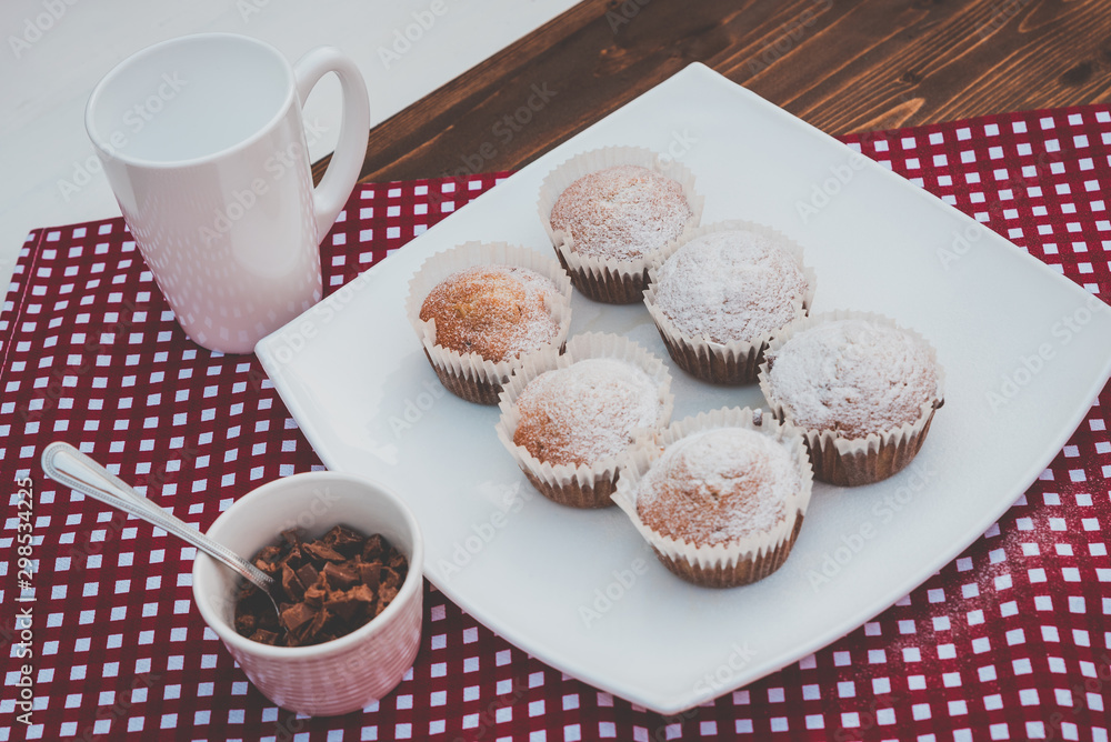 sweet muffins on a plate with a cup of chocolate sweet muffins on a plate with a cup of chocolate