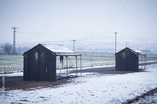 depressing scenery. countryside with wood huts on winter day