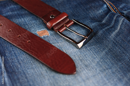 men's leather trouser belt in the background of denim, men's closet, jeans