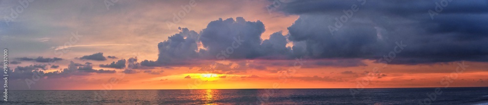 Phuket beach sunset, colorful cloudy twilight sky reflecting on the sand gazing at the Indian Ocean, Thailand, Asia. Phuket beach sunset, colorful cloudy twilight sky reflecting on the sand gazing at the Indian Ocean, Thailand, Asia.