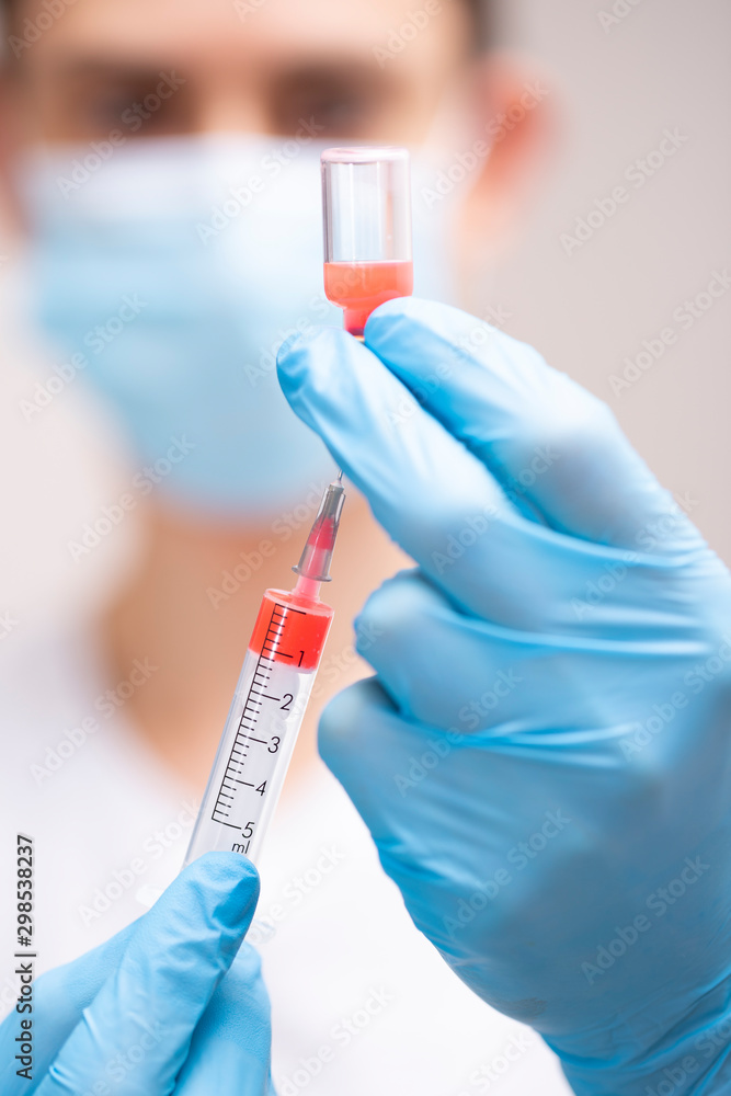Doctor with syringe in blue gloves (vertical, 6455) Doctor with syringe in blue gloves (vertical, 6455)