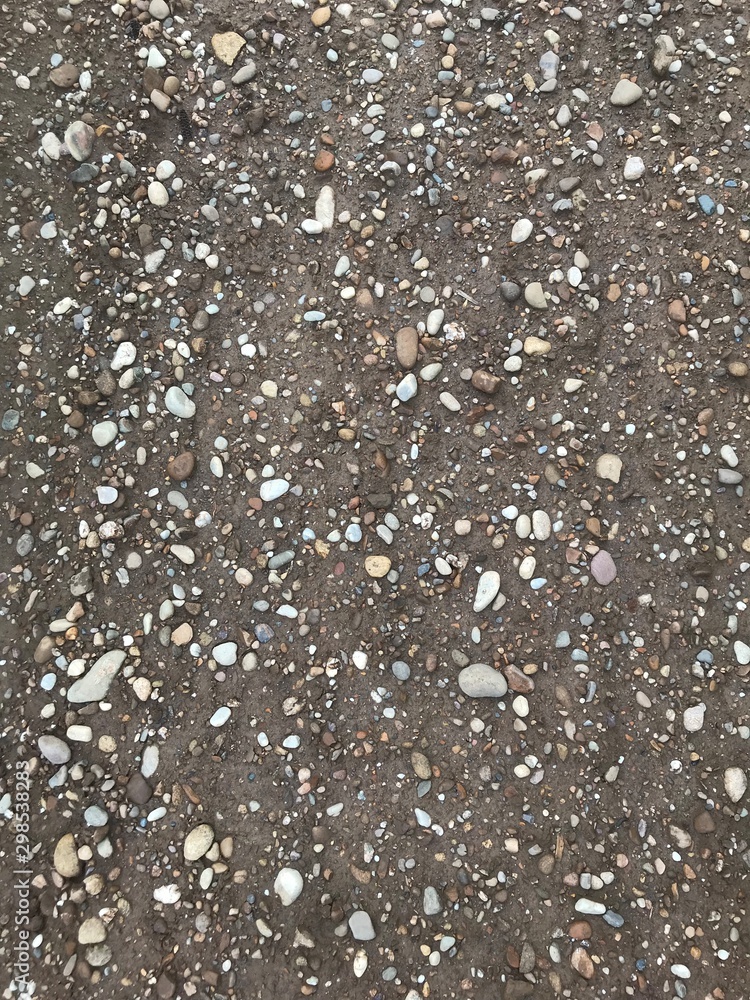 Brown soil with bright stones after rain Brown soil with bright stones after rain