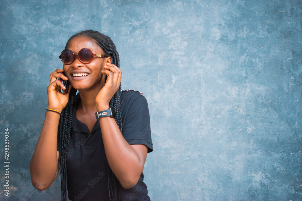 a beautiful young African woman feels surprised by what she saw on her phone a beautiful young African woman feels surprised by what she saw on her phone