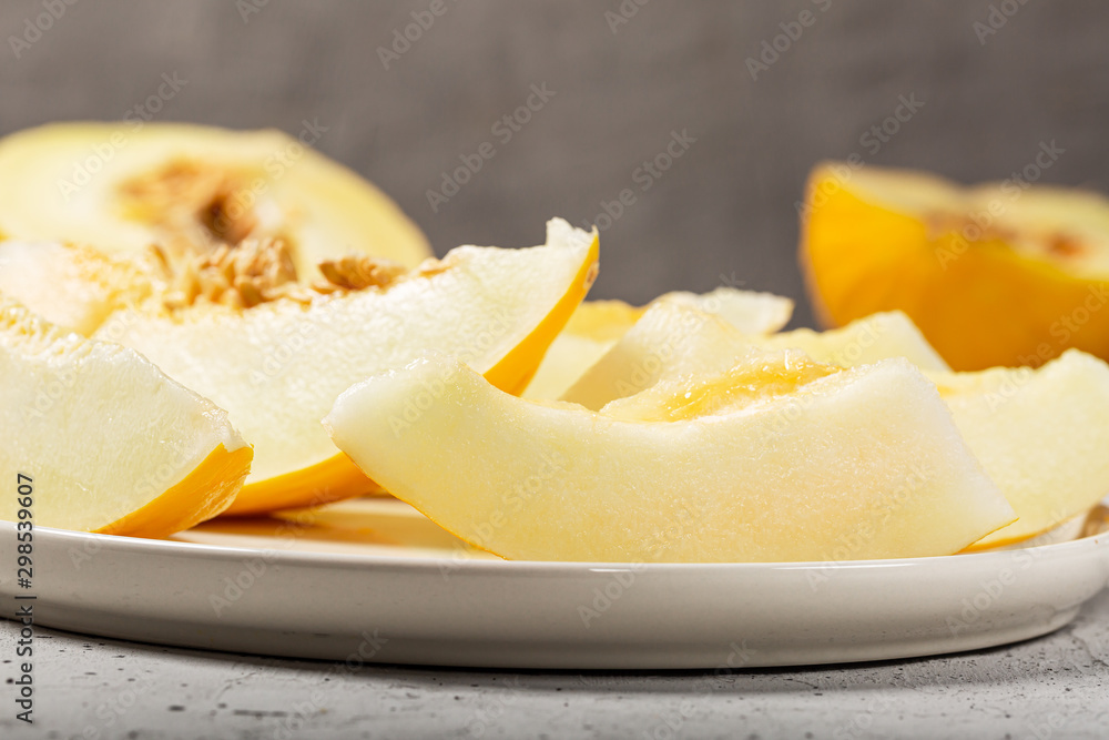 Sweet yellow fresh melon on white concrete table Sweet yellow fresh melon on white concrete table