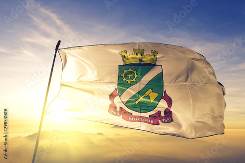 Brusque of Brazil flag waving on the top sunrise mist fog
