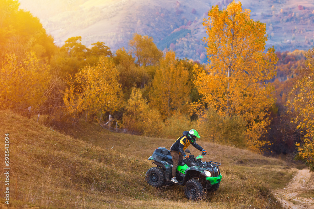 All terrain vehicles, quad bikes, atv, riding through beautiful rural scenery in autumn