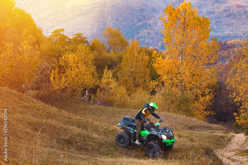Fototapeta Naklejka Na Ścianę i Meble -  All terrain vehicles, quad bikes, atv, riding through beautiful rural scenery in autumn