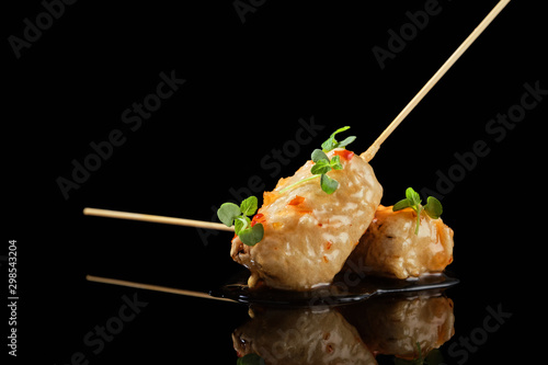 Food in batter on a black background with flowers