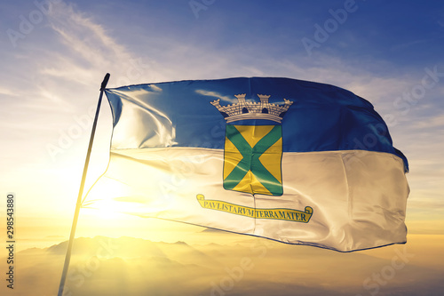 Santo Andre of Brazil flag waving on the top sunrise mist fog
