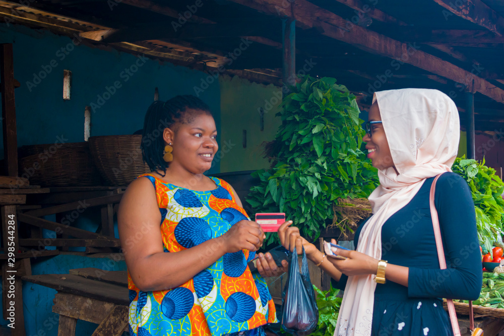 market-woman-receiving-credit-card-from-her-customer-to-pay-her-bills