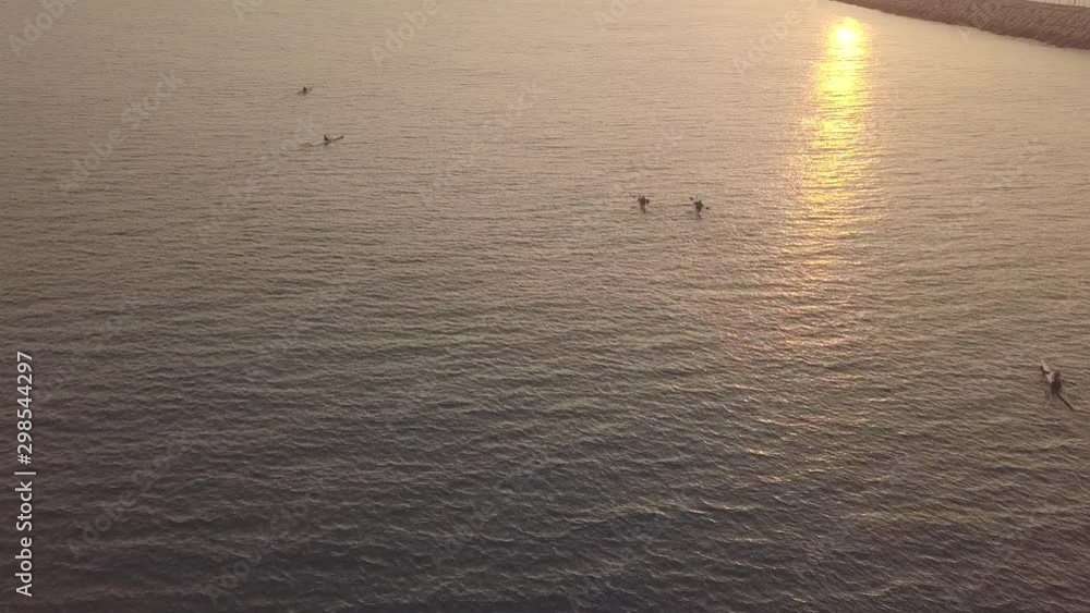 Long, narrow and fast racing sea kayaks. Early morning on a background of amazing sunrise. Long, narrow and fast racing sea kayaks. Early morning on a background of amazing sunrise.