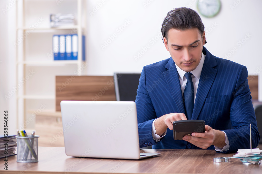 Young male businessman working in the office Young male businessman working in the office